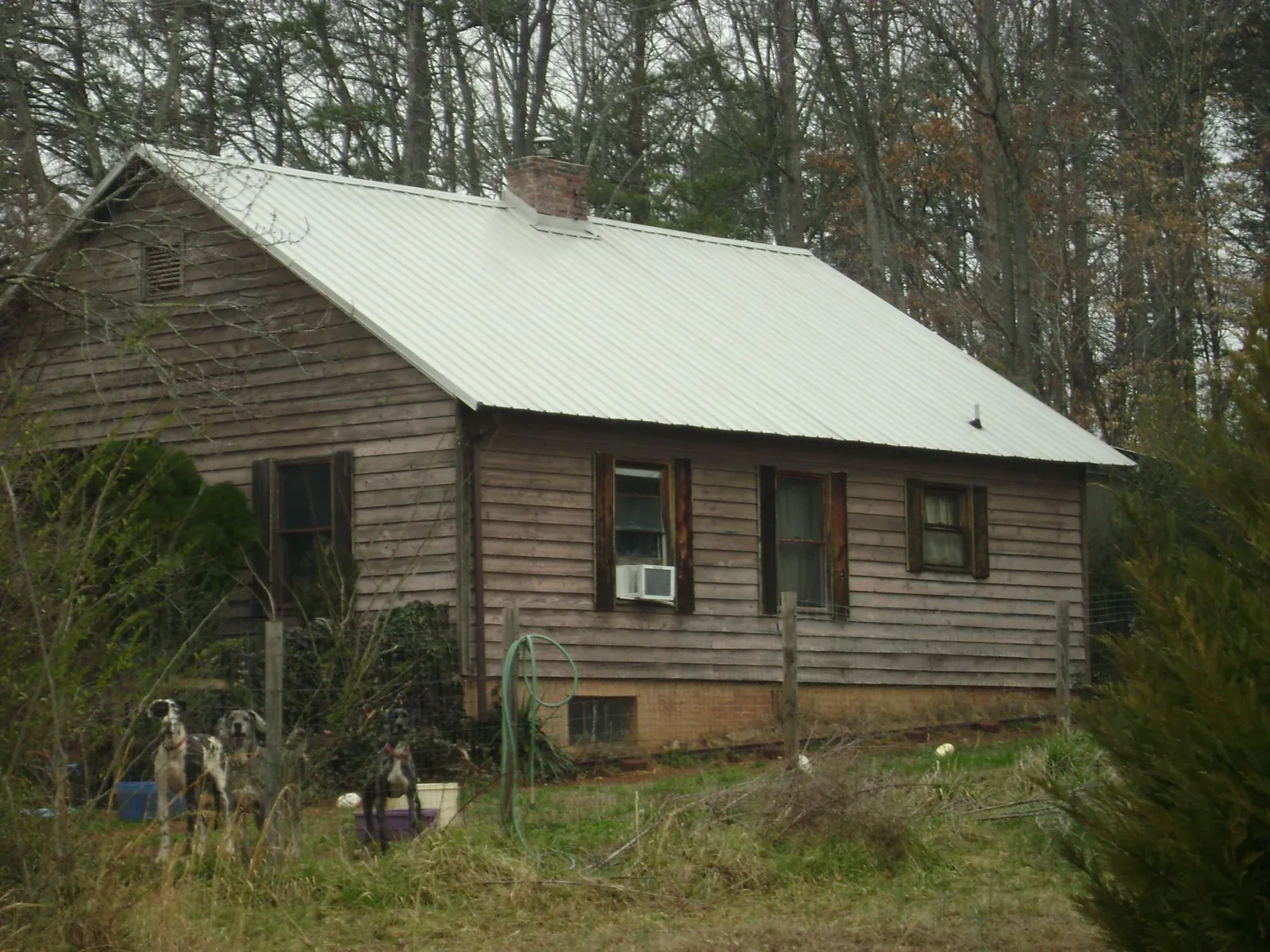 White metal roof on an old wood sided farmhouse, from a Metal Roof Installation job in Newport
